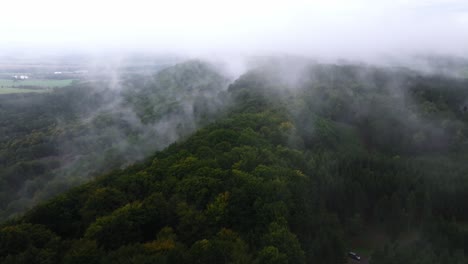 Dense-forests-on-a-hill-shrouded-in-morning-mist-after-rain