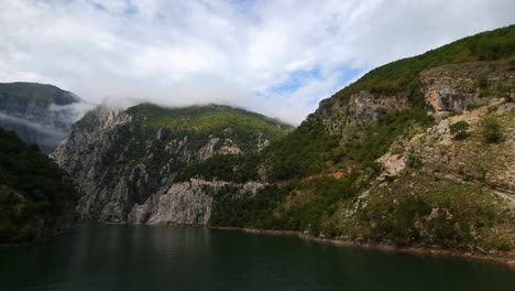 Serene-Lake-of-Koman:-Calm,-Deep-Green-Waters-Set-Against-the-Majestic-Rocky-Slopes-of-the-Albanian-Alps-Mountains