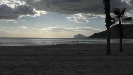 Calpe-Spain-Timelapse-on-the-beach-just-before-sunset-with-dark-clouds-drifting-by