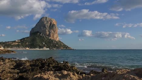 Timelapse-Calpe-Pina-De-IFac-waves-lapping-on-beach-and-fishing-boats-returning-to-harbour-on-a-warm-summer-evening
