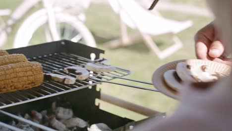 Close-up-video-of-boy-putting-mushrooms-on-the-grill