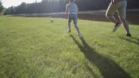 Tracking-video-of-father-and-son-training-soccer-on-holiday