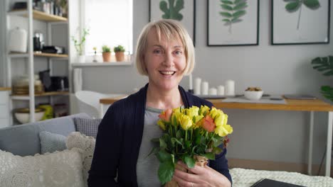 Video-portrait-of-senior-woman-with-bouquet-of-flowers