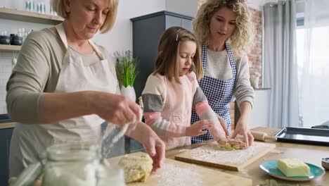 Video-of-three-women-kneading-dough-in-the-kitchen