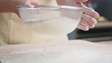 Close-up-video-of-sifting-flour-in-domestic-kitchen