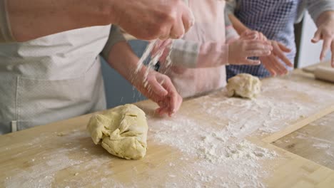Close-up-video-of-sprinkling-flour-and-kneading-dough