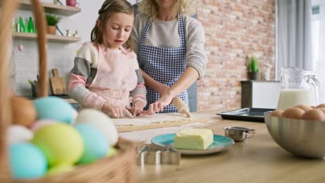 Tracking-video-of-three-generations-of-women-preparing-Easter-cake