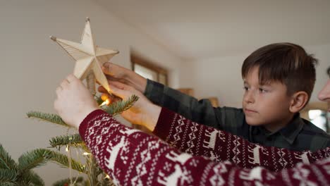 Father-and-son-decorating-the-Christmas-tree