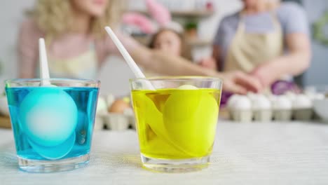 Close-up-video-of-drinking-glasses-with-dyes-for-coloring-eggs