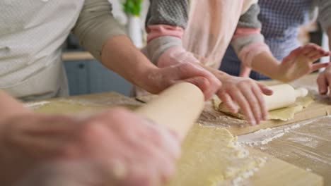 Close-up-video-of-three-women-rolling-dough