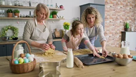 Video-of-three-generations-of-women-preparing-Easter-cookies-together