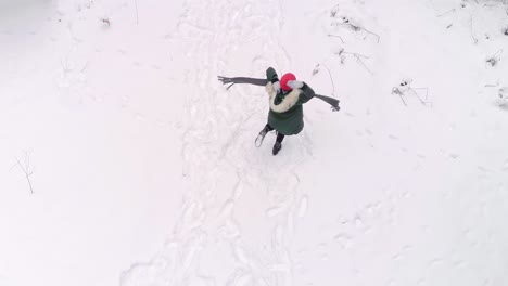 Aerial-view-of-happy-woman-dancing-in-winter-forest