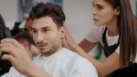 Handheld-view-of-man-having-visit-to-the-hairdresser