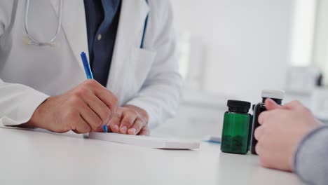 Handheld-view-of-doctor-writing-a-prescription-for-his-patient