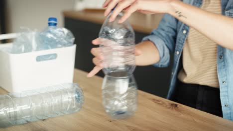Video-of-woman-crushing-plastic-bottles