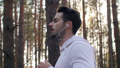 Side-view-of-man-running-and-listening-to-music