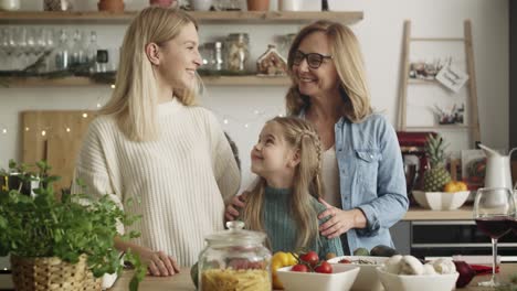 Video-portrait-of-three-generations-of-women-in-kitchen