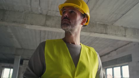 Close-up-low-angle-footage-of-caucasian-engineer-browsing-a-digital-tablet-on-construction-site.