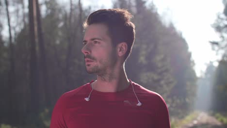 Portrait-of-smiling-runner-in-the-forest