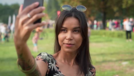 Woman-meet-friends-and-making-selfie-at-music-festival.