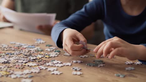 Video-of-son-solving-jigsaw-puzzle-during-father-working-at-home