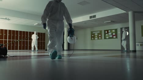Static-video-of-sanitation-worker-disinfecting-of-building-hallway.