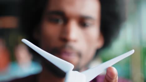 Close-up-of-African-man-holding-model-of-wind-turbine