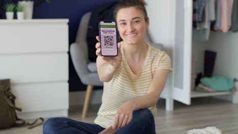 Tracking-video-of-woman-holding-phone-with-digital-vaccination-card