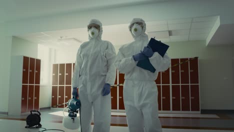 Tracking-video-of-team-in-disinfection-suits-ready-for-disinfection