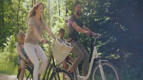 Video-of-playful-family-riding-bikes-in-the-woods