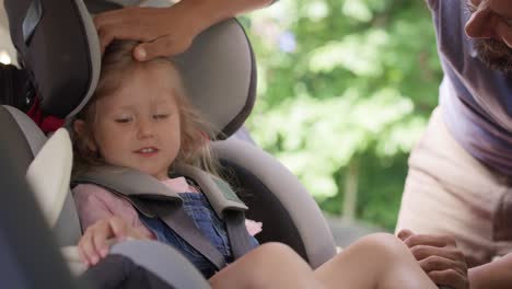 Video-of-father-securing-daughter-to-a-baby-car-seat.