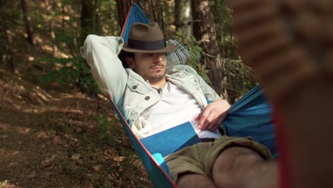 Man-taking-a-nap-on-the-hammock-in-the-forest