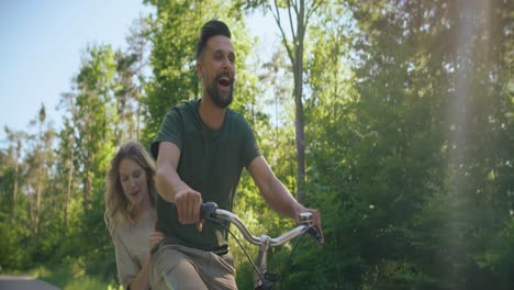 Video-of-playful-couple-having-fun-on-a-bike