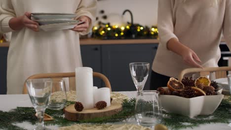 Family-preparing-dinning-table-for-Christmas-Eve