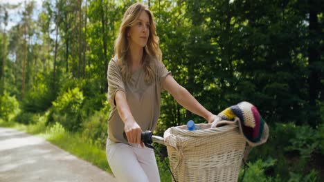Video-of-woman-riding-a-bike-on-a-sunny-day.