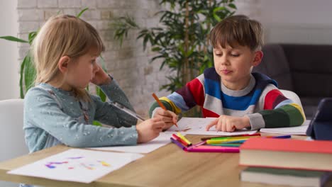 Handheld-video-of-polite-sibling-doing-homework-together-at-home
