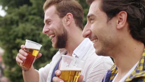 Mature-men-drinking-beer-at-the-music-festival