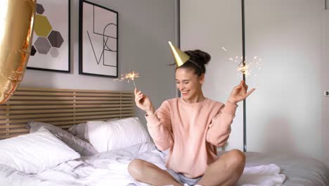 Woman-with-star-shaped-sparklers-celebrating-her-birthday-in-bed