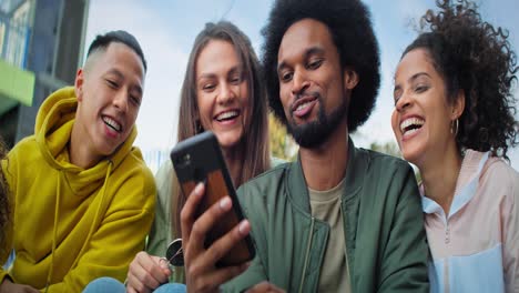 Handheld-video-of-group-of-best-friends-using--mobile-phone