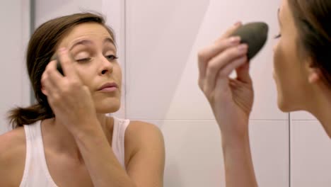 Beautiful-woman-doing-the-make-up-in-bathroom