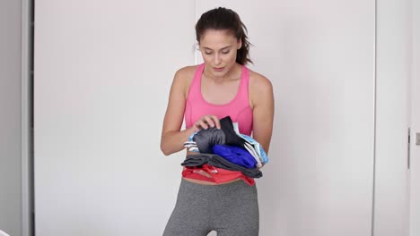 Woman-preparing-gym-bag-at-home