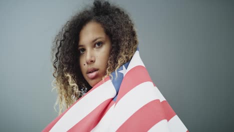 Video-of-proud-woman-holding-American-flag
