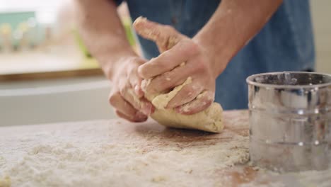 Handheld-view-of-man’s-hands-kneading-dough