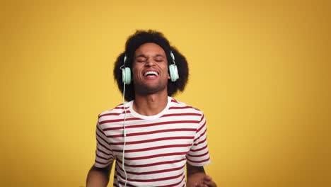 Young-man-having-fun-during-listening-music-and-dancing