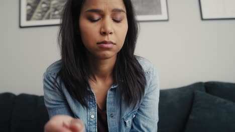 Tilt-up-video-of-broken-mixed-race-woman-holding-an-ultrasound-scan-and-feeling-negative-emotions.