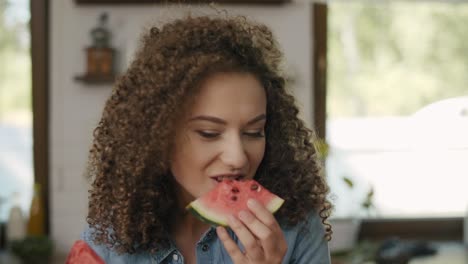 Beautiful-woman-eating-a-watermelon-in-the-kitchen/Rzeszow/Poland