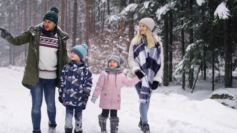 Handheld-video-of-family-walking-in-the-winter-forest
