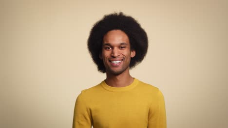 Portrait-of-a-young-man-smiling-in-studio-shot