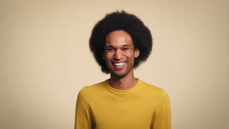 Young-African-man-laughing-in-studio-shot
