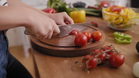 Handheld-view-of-wooden-board-and-freshness-tomatoes-slices/Rzeszow/Poland